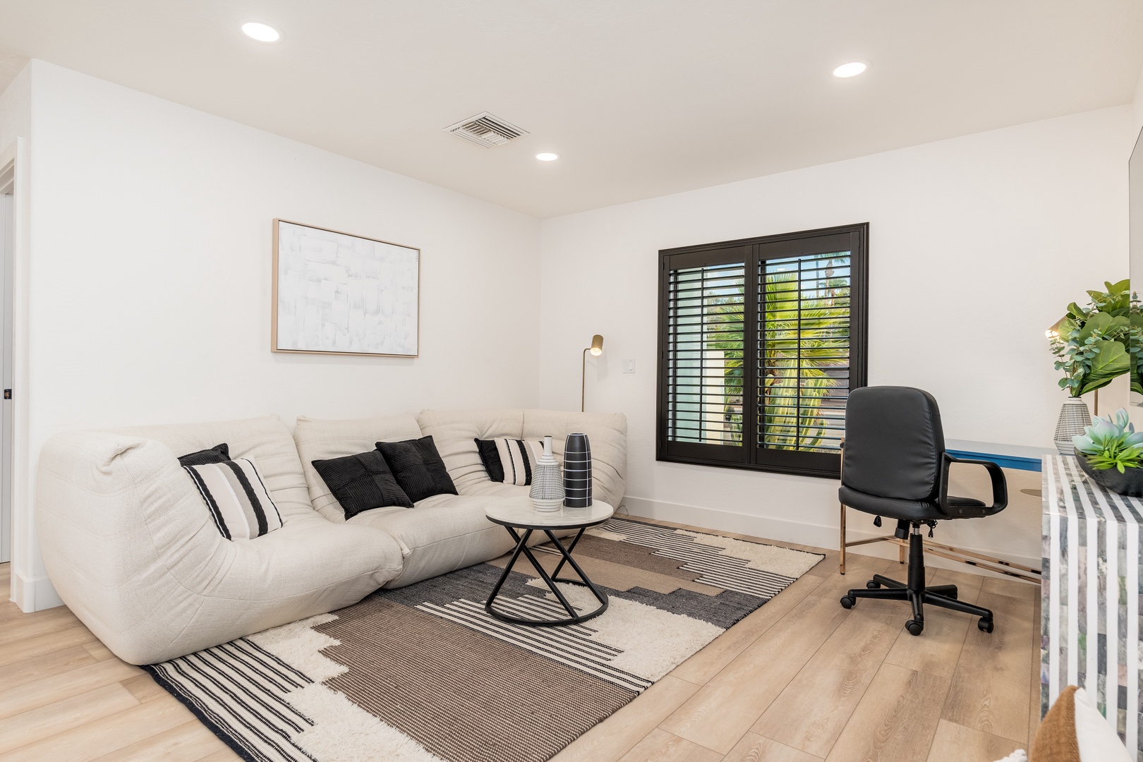 Settle into your bright, comfortable living space with plush seating, modern decor, and a dedicated work area—perfect for relaxing or staying productive during your stay.