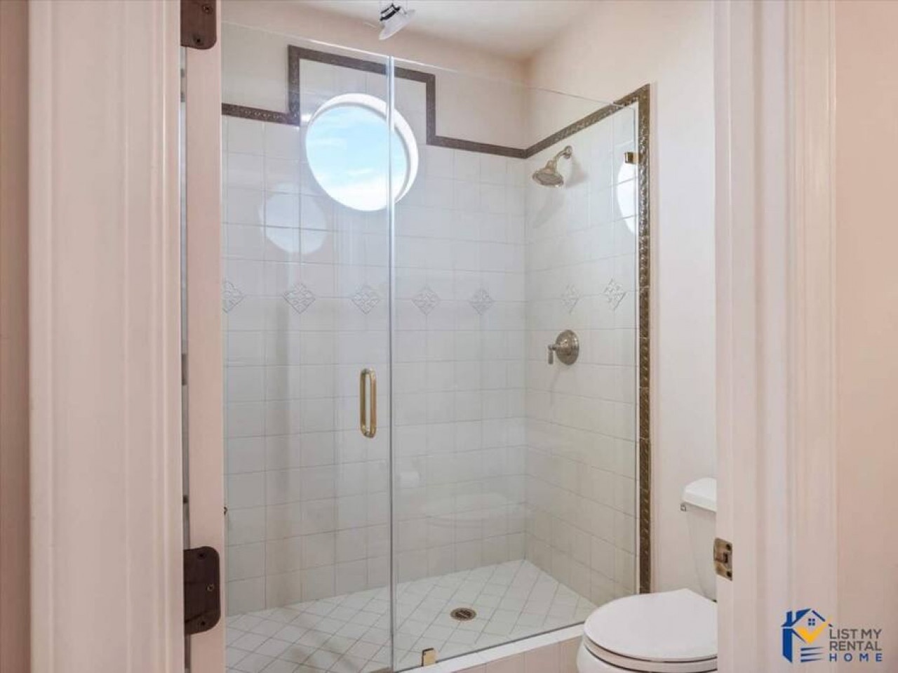 Step into your spa-like shower sanctuary with elegant tiling and glass doors for a refreshing start to your day.