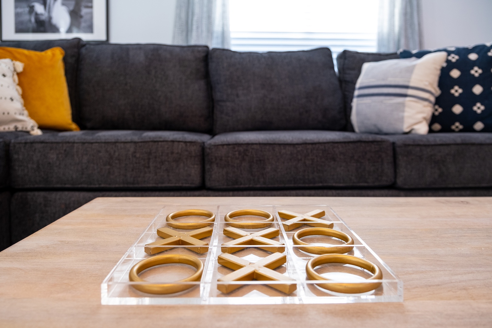 Settle in on your plush sofa and enjoy a friendly game of tic-tac-toe on the coffee table, surrounded by cozy pillows and natural light.