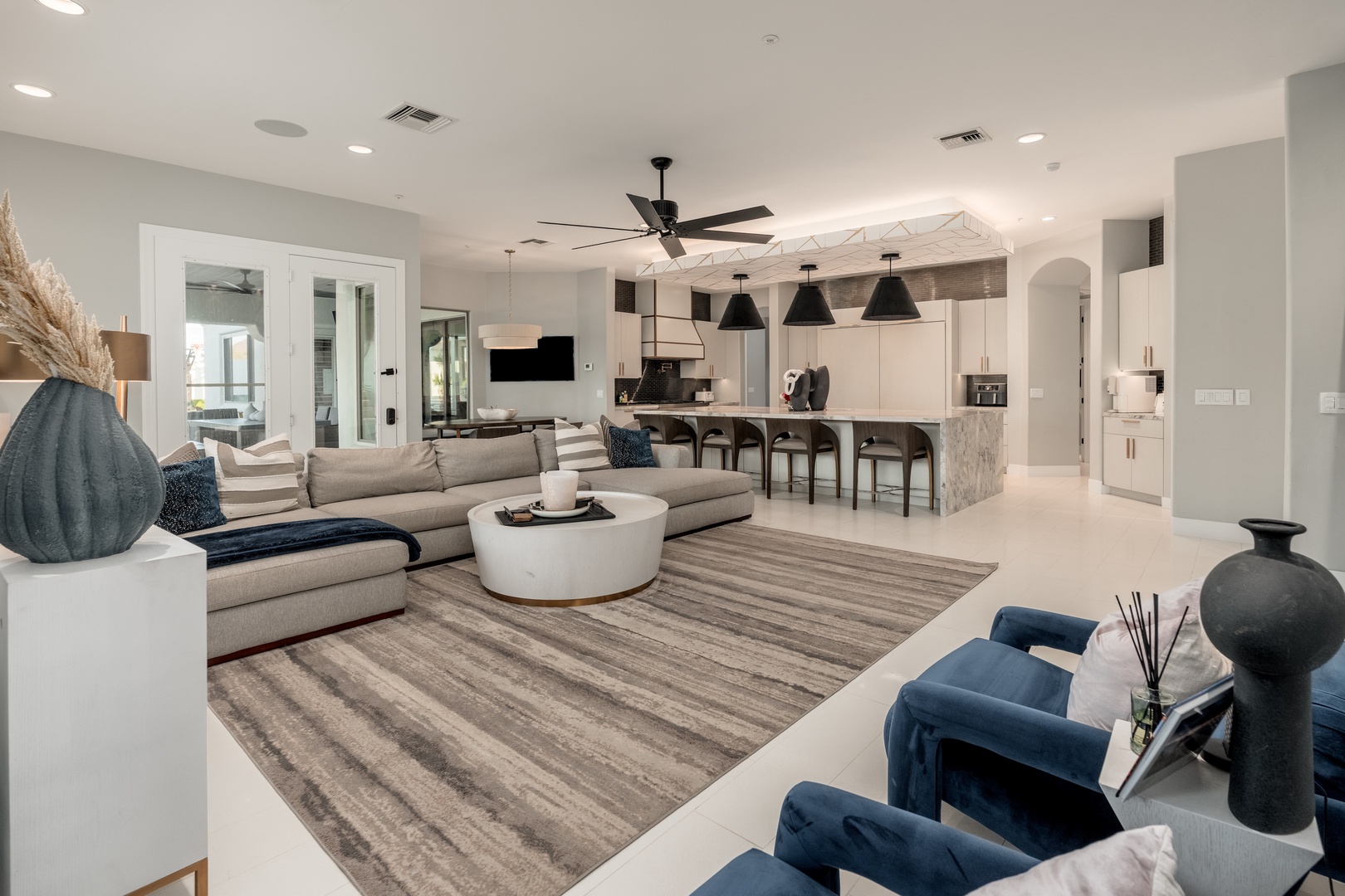 Unwind in this spacious open-concept living area with modern furnishings, sleek kitchen island, and thoughtful design. Your perfect retreat flows seamlessly from cozy seating to stylish dining.