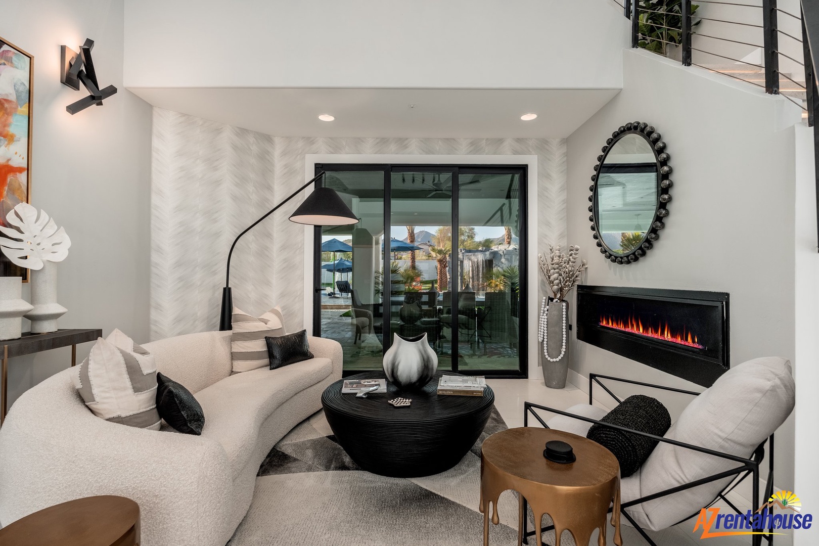 Relax in your stylish living space with modern furnishings, cozy fireplace, and seamless indoor-outdoor flow through sliding glass doors.