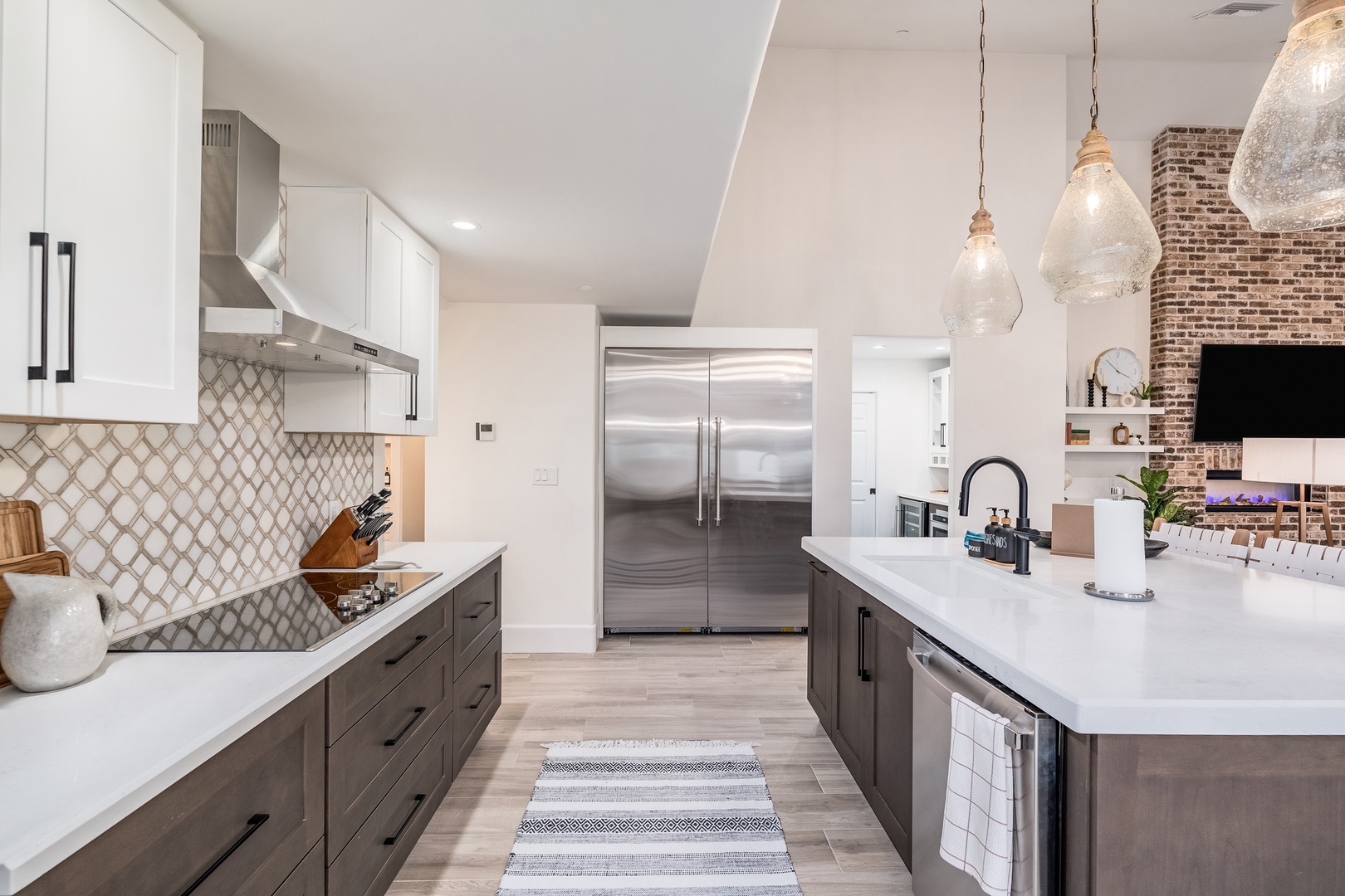Picture yourself preparing meals in this modern, fully-equipped kitchen with sleek countertops, custom cabinetry, and an inviting island perfect for entertaining or casual dining.