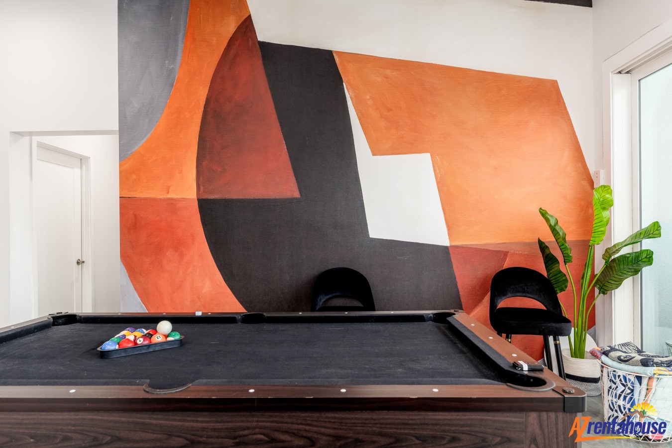 Challenge friends to a game at your stylish pool table, surrounded by bold modern art and comfortable seating.