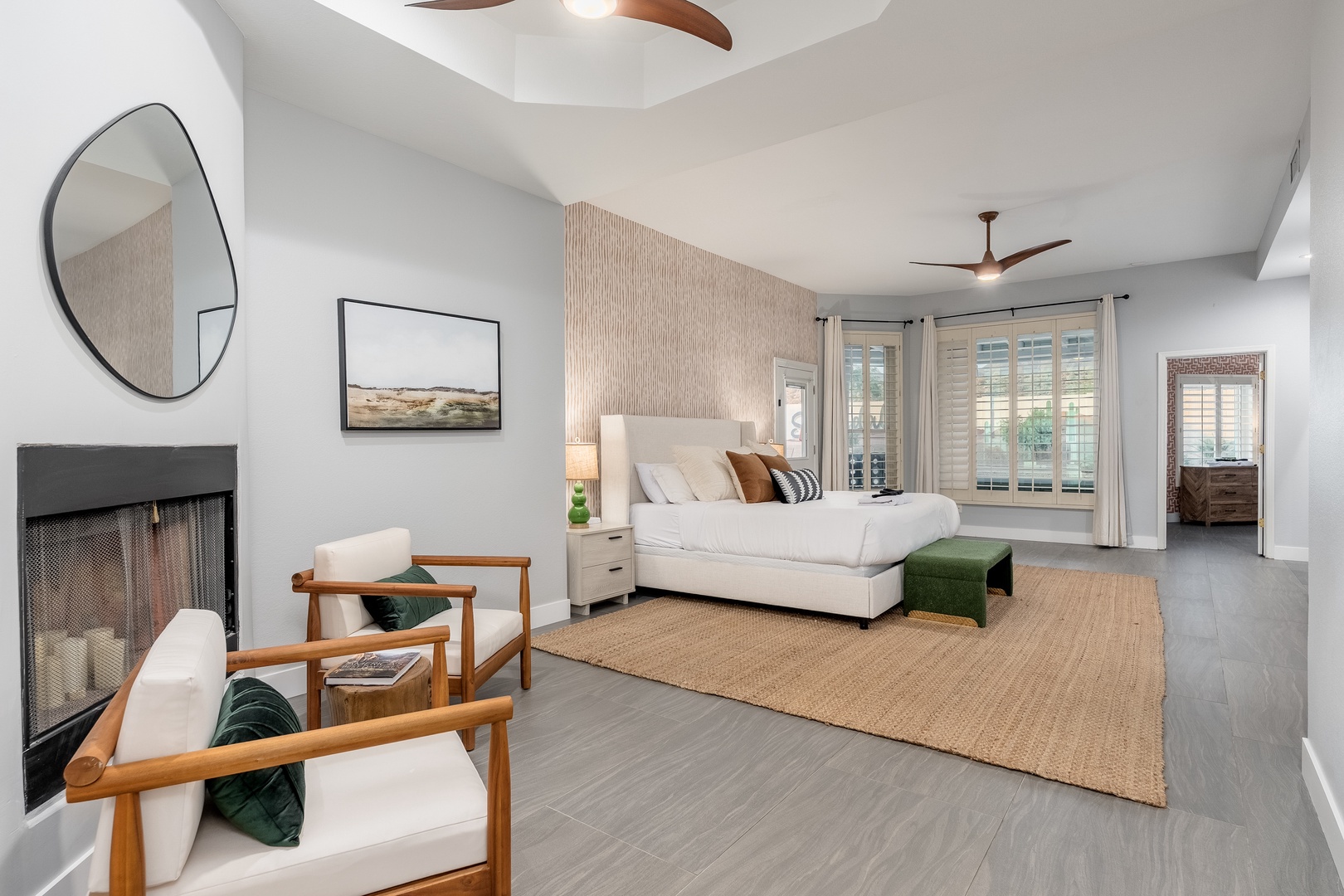 Unwind in this serene retreat where soft textures and natural tones create your perfect escape. Ceiling fans gently cool the air as you sink into plush seating or rest on the inviting bed, ready for peaceful nights and lazy mornings.