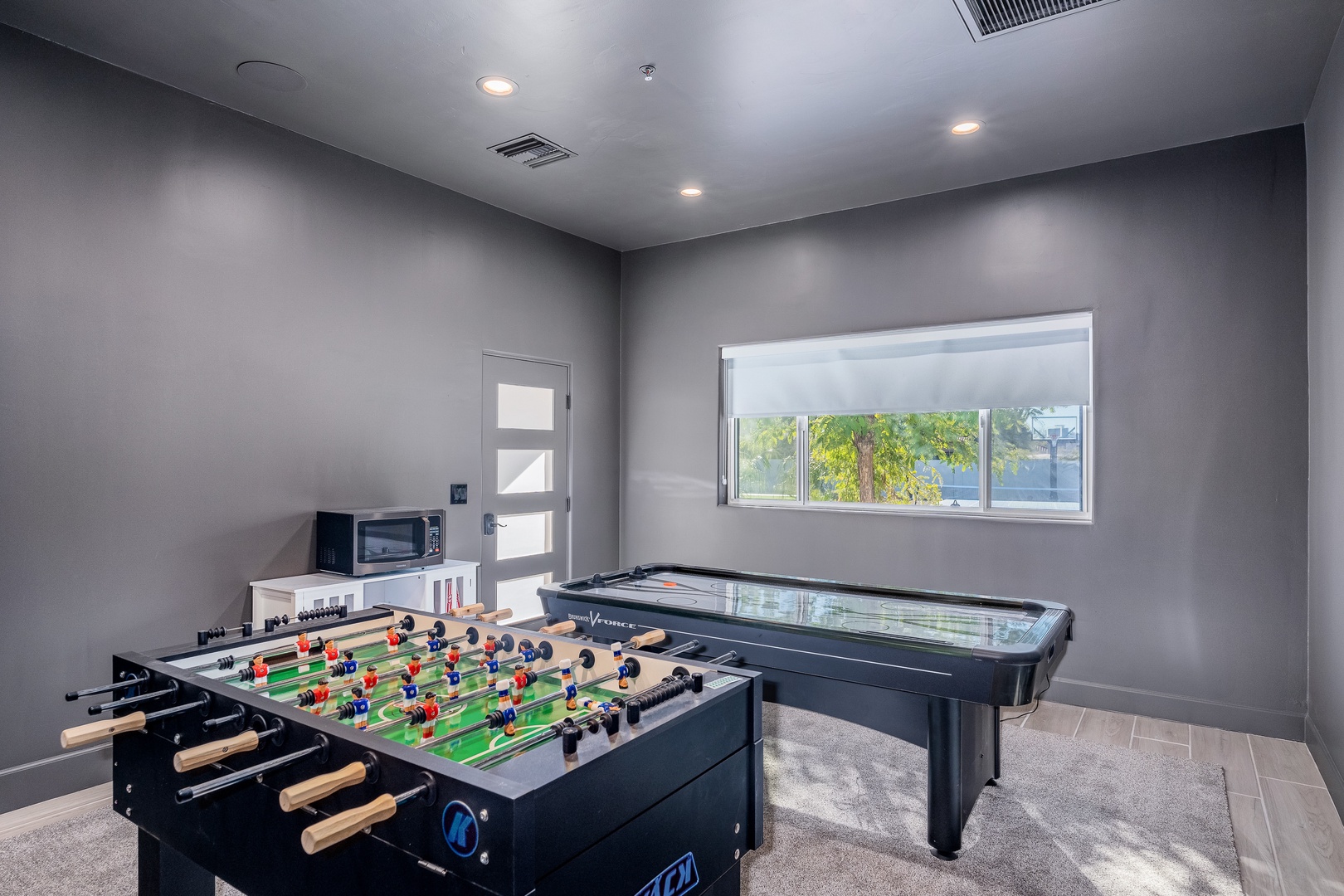 Challenge friends to foosball or air hockey in your private game room, where sunshine streams through the window and friendly competition awaits.