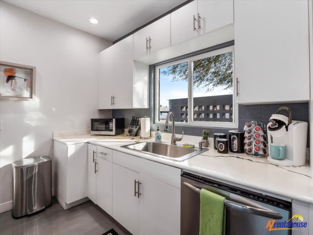 Your sleek modern kitchen features white cabinets, stainless appliances, and everything you need to prepare meals during your stay.
