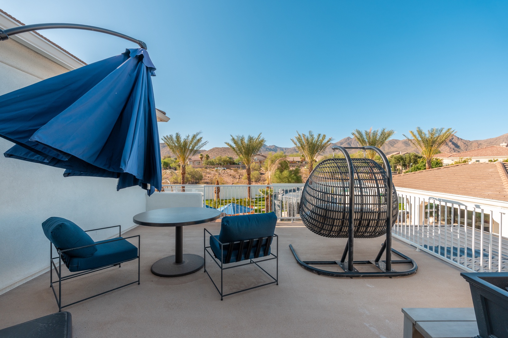 Unwind in your private balcony oasis with sweeping desert and mountain views. Lounge chairs and a hanging chair create the perfect spot for morning coffee or sunset cocktails.