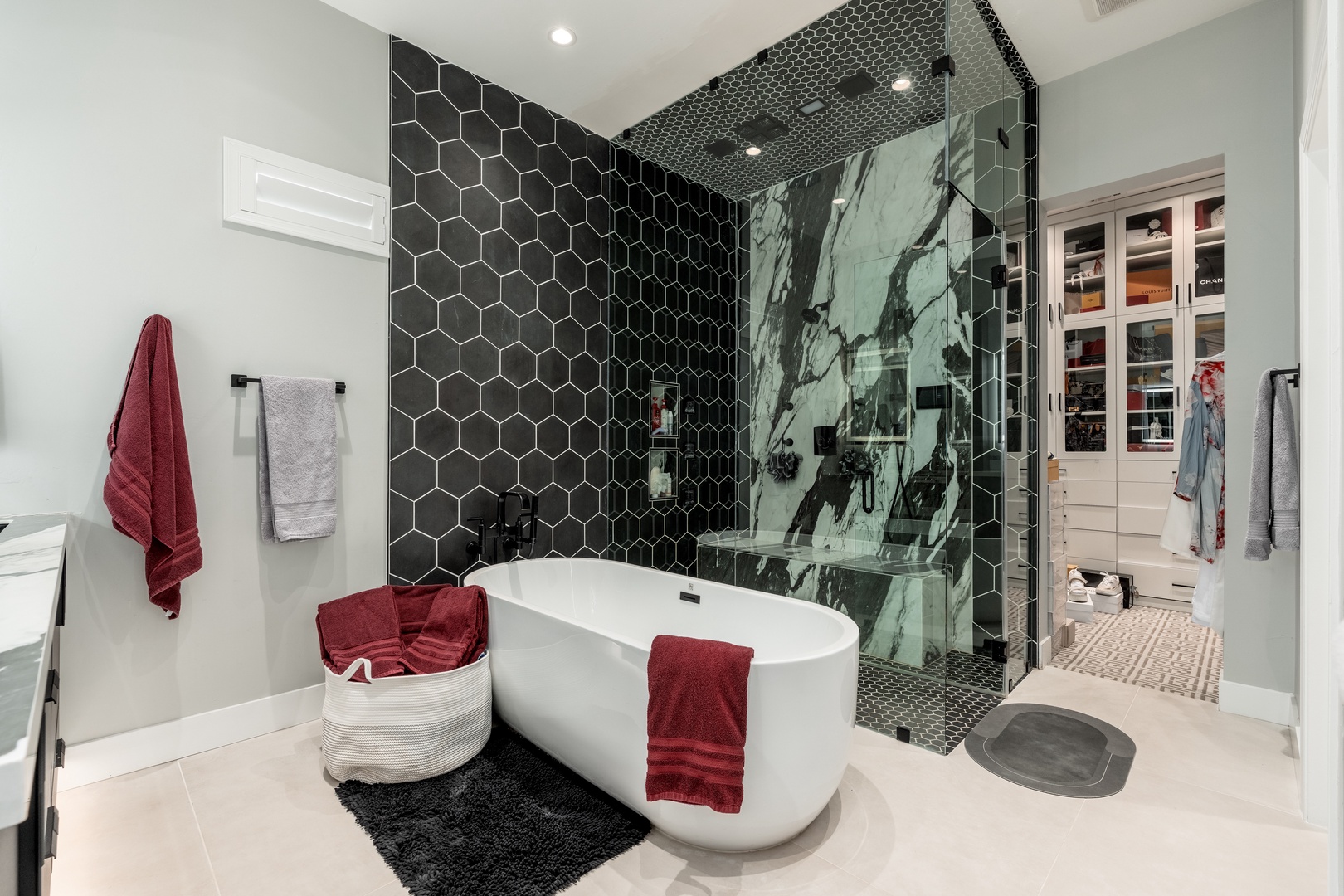 Immerse yourself in a spa-like retreat with striking honeycomb tile, a luxurious soaking tub, and a spacious walk-in shower that elevates your daily routine into pure indulgence.