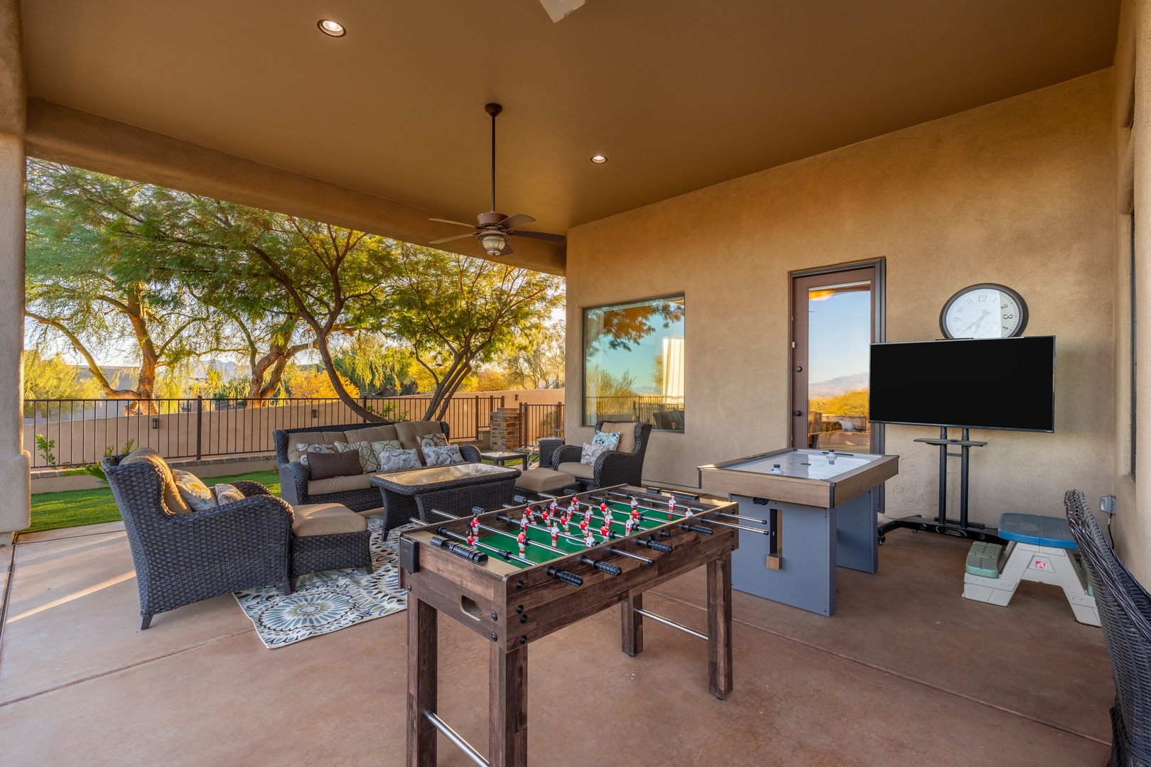 A covered outdoor space with foosball, table games, and cozy seating invites you to unwind while enjoying desert views and warm Arizona light.