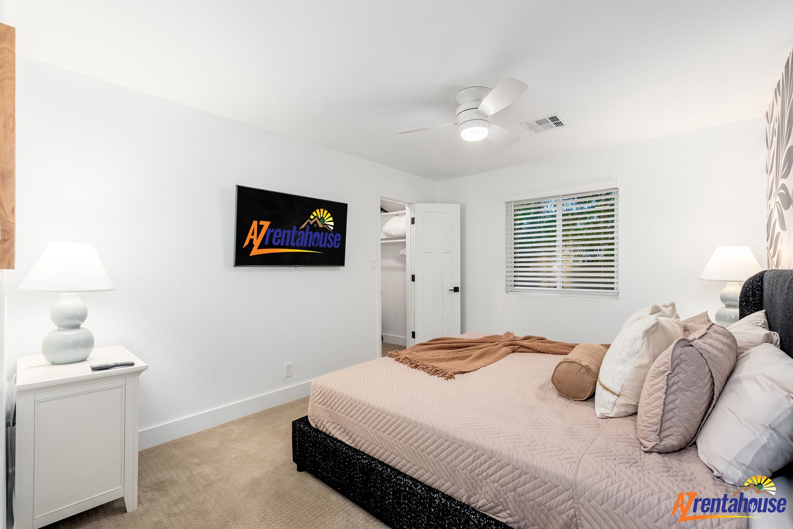 Sink into plush bedding in your peaceful bedroom, complete with entertainment and gentle natural light from window blinds.