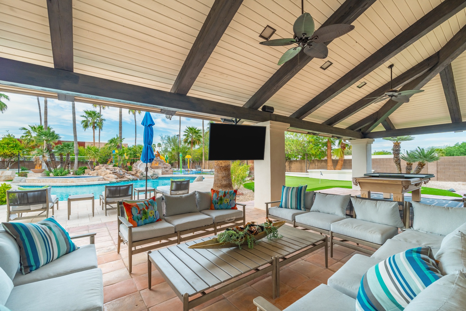 Gather with friends under soaring beams and ceiling fans as you enjoy poolside lounging, outdoor TV, and direct access to your private oasis.