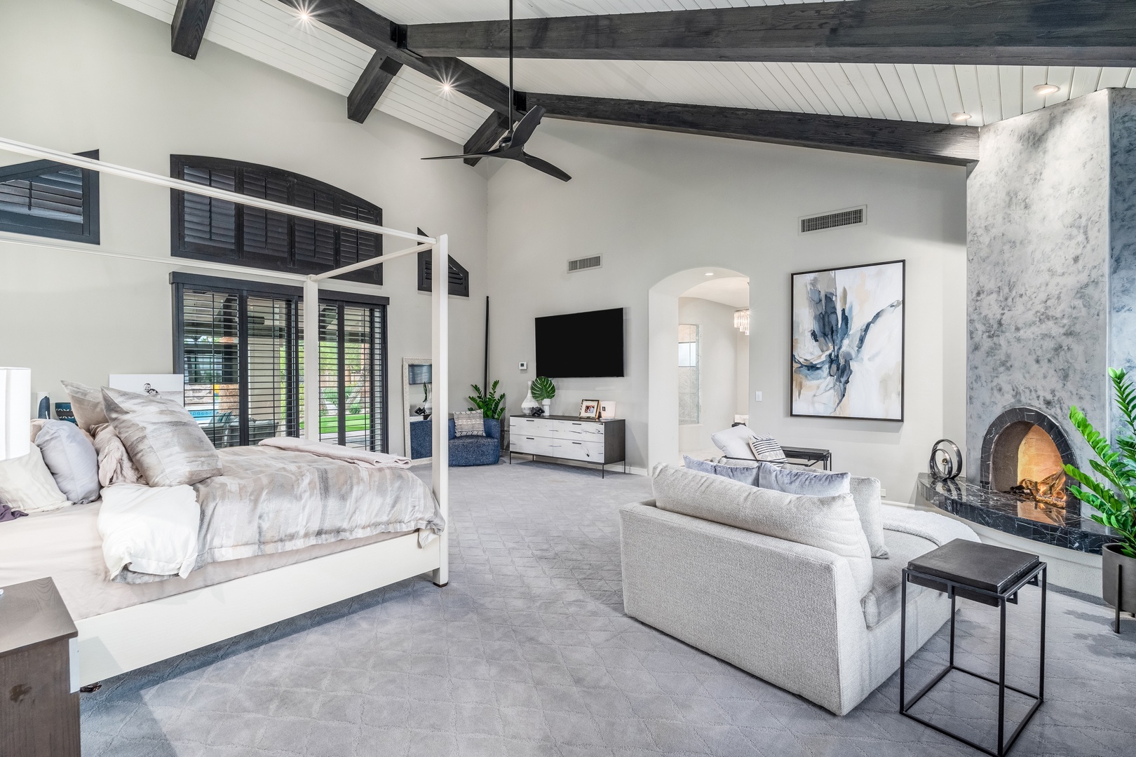 Unwind in your spacious suite with vaulted ceilings, exposed beams, plush seating, and a cozy fireplace for ultimate relaxation.