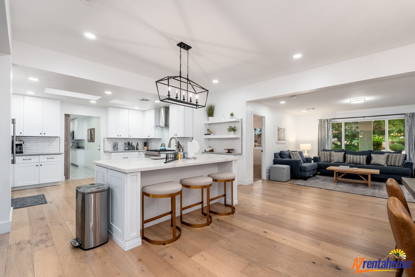 Gather around this stunning open-concept space where modern elegance meets comfort—your perfect hub for cooking, dining, and relaxing together.