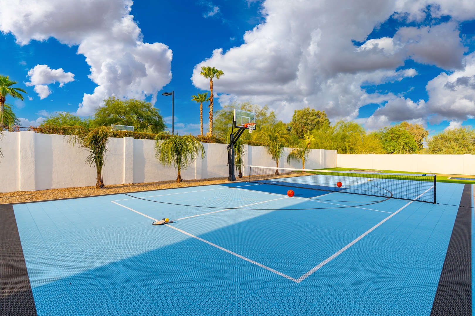 A multi-sport court surrounded by palm trees offers endless fun under sunny skies—perfect for friendly matches of tennis, pickleball, or basketball during your stay.