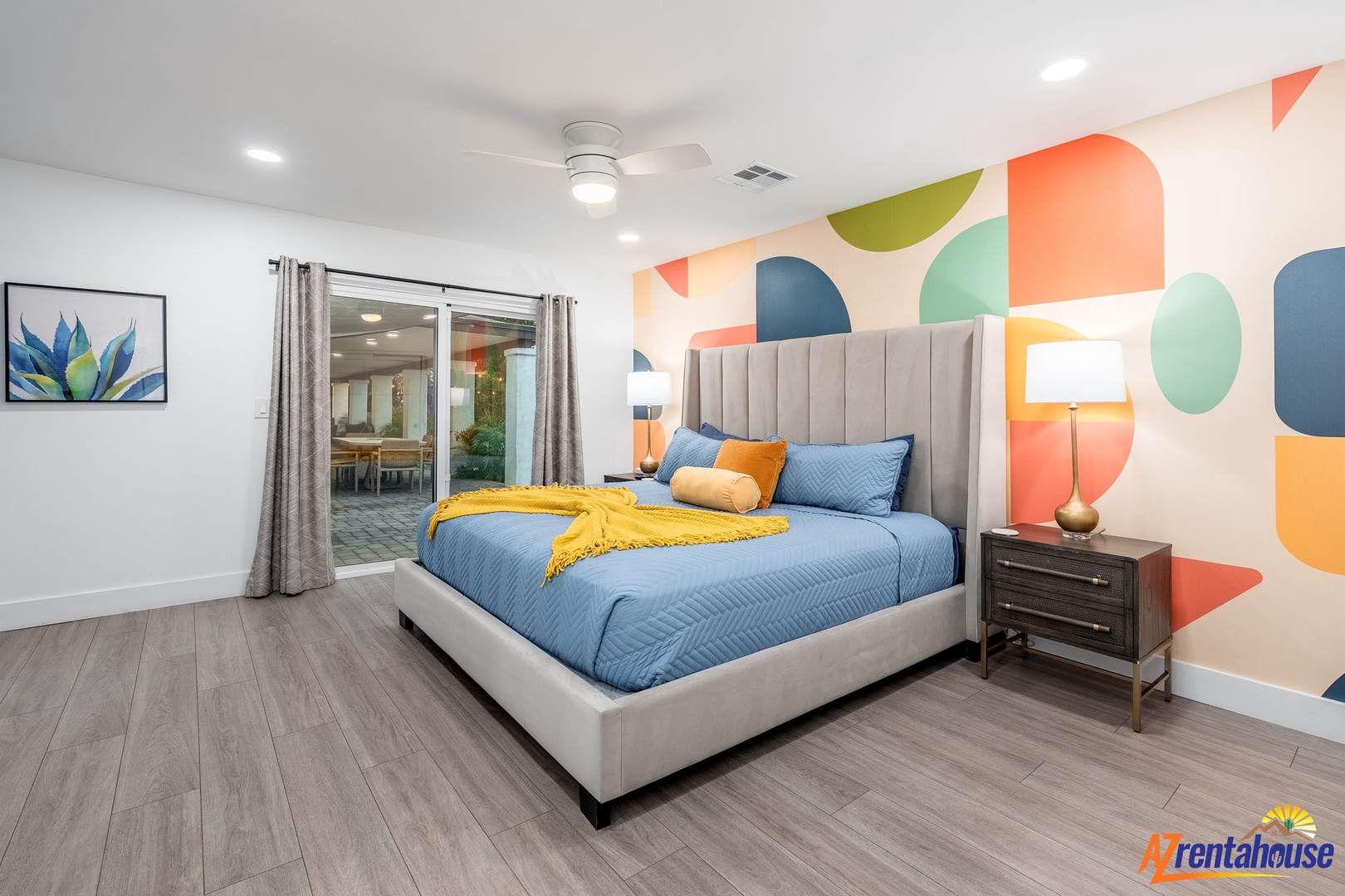 Drift into dreamland surrounded by vibrant geometric art and plush comfort in your stylish bedroom retreat.
