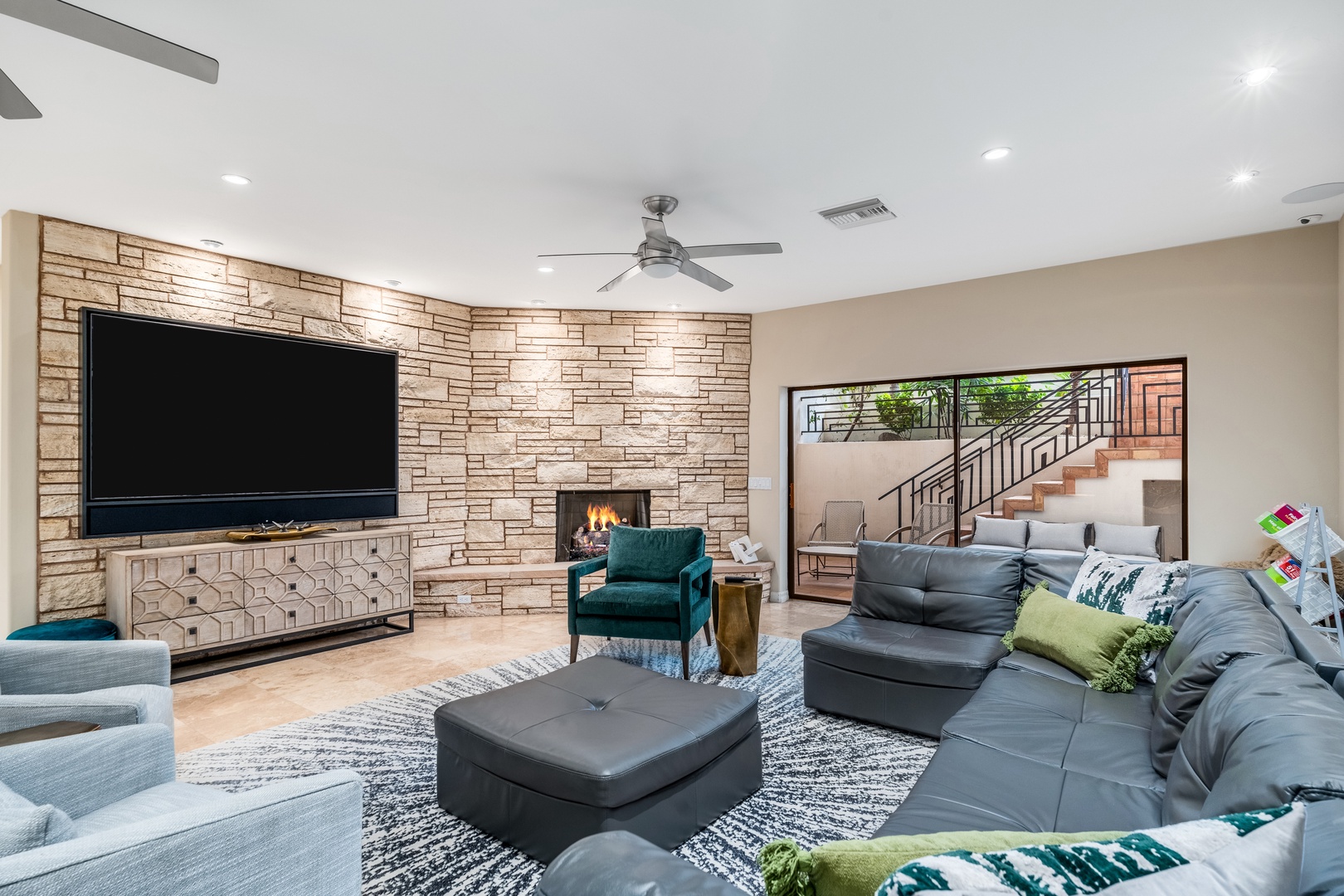 Settle into plush seating and unwind by the warmth of your own fireplace. Modern comfort meets inviting design in this spacious living area, perfect for your evening relaxation.