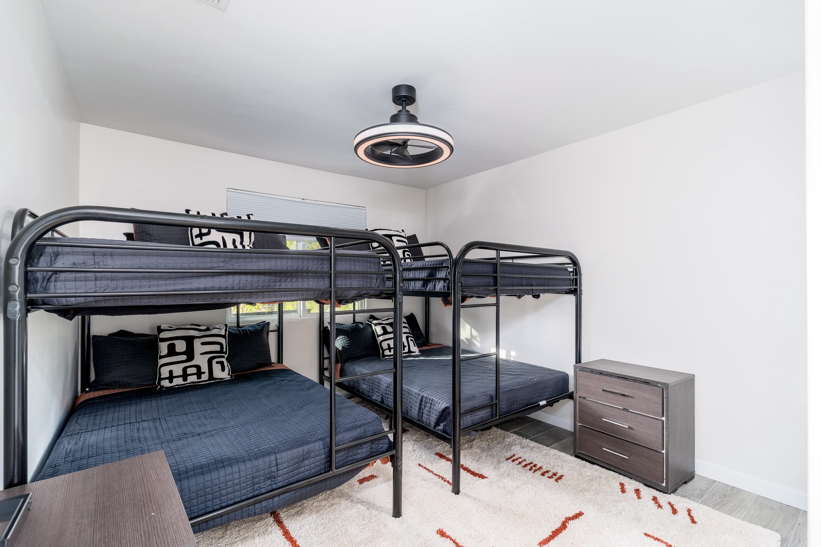 Perfect for families or groups, this room features space-efficient bunk beds dressed in crisp linens, plus a ceiling fan and ample storage for your belongings.
