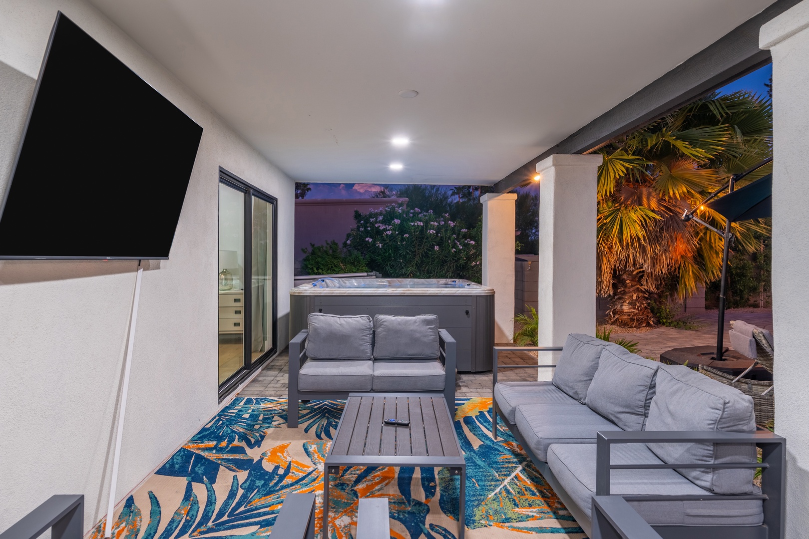 Slip into the hot tub under the stars, or sink into plush outdoor seating with a movie on the big screen—your private patio retreat awaits.