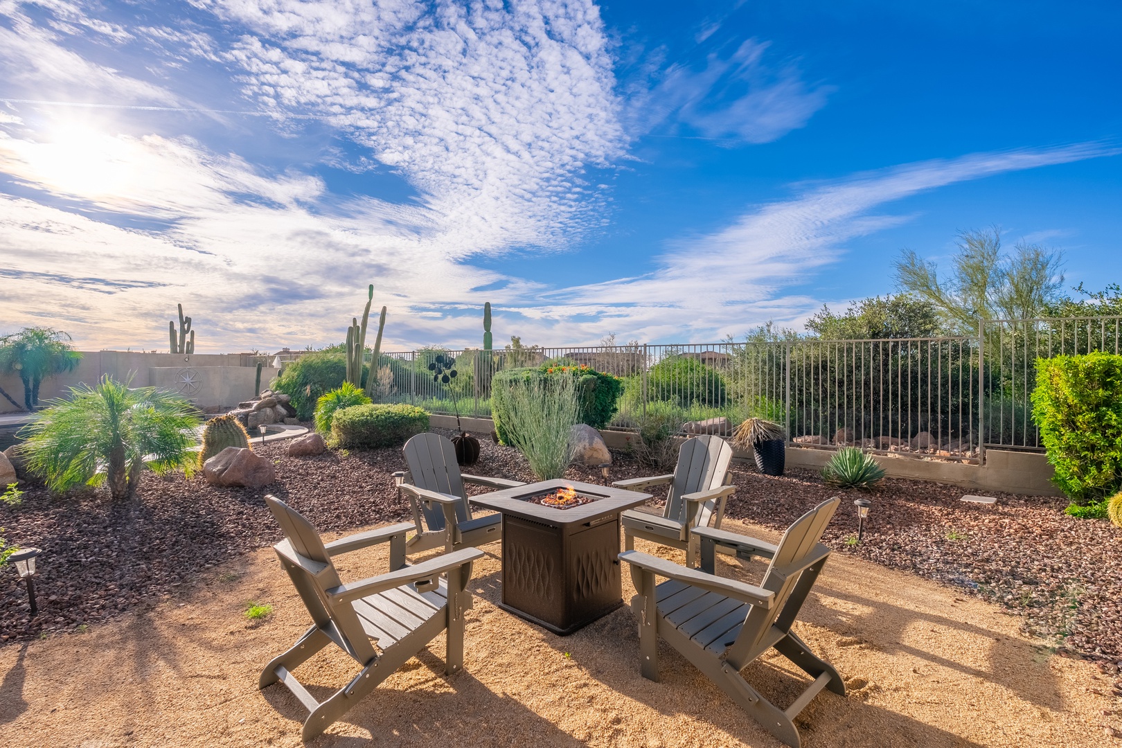 Gather around your private fire pit and soak in stunning desert views framed by towering saguaros and a sky painted in soft clouds and golden light.