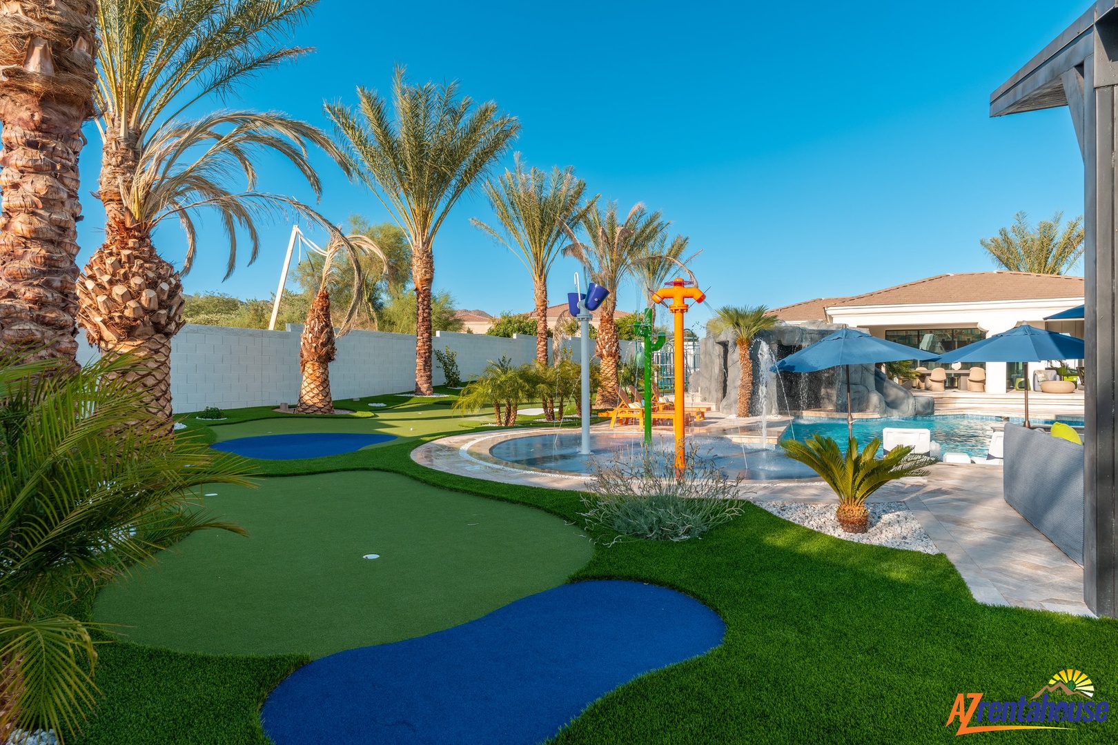 A tropical paradise featuring miniature golf, children's water play area, and swimming pool surrounded by lush palm trees.