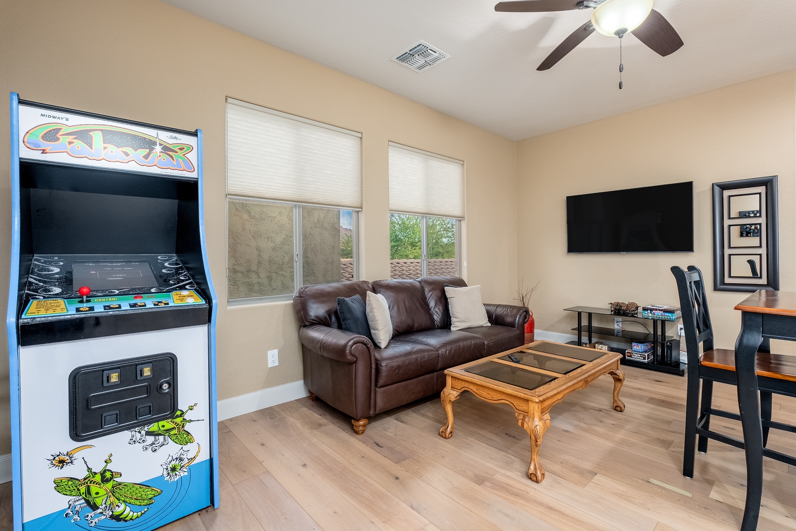 Game on! Your private game room invites you to unwind with classic arcade fun, a cozy leather sofa, and a big-screen TV for movie nights or gaming marathons.
