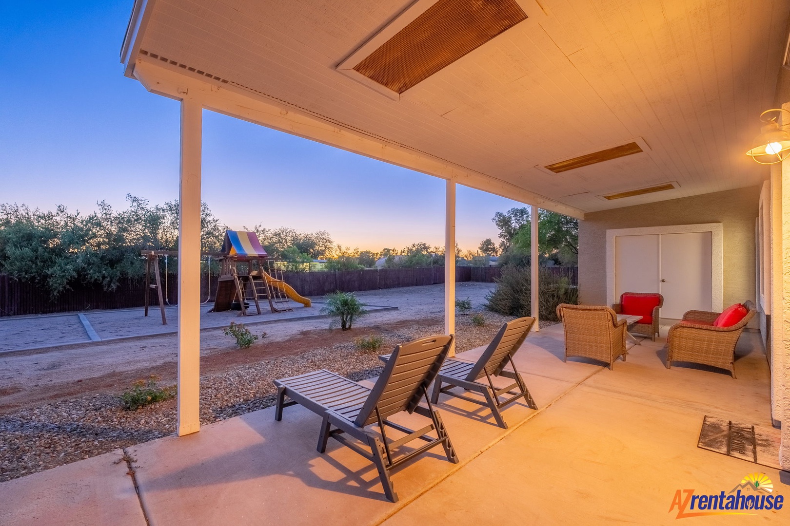 Relax in your covered patio as the sun sets, with cozy seating and a playground for the kids. Perfect for peaceful evenings and family fun in your private backyard oasis.