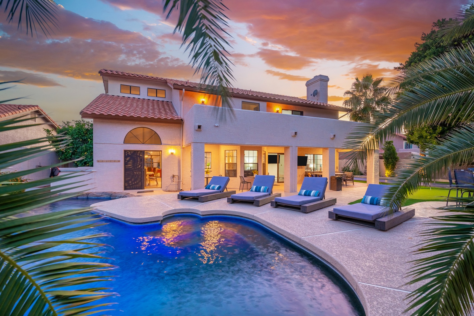 Stunning desert retreat with private pool and palm-framed views, bathed in warm sunset light, creating an inviting backdrop for relaxation and memorable evenings.