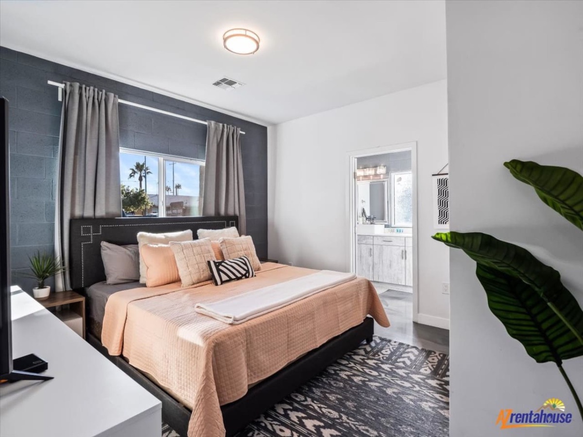Unwind in your stylish bedroom featuring a plush king bed, contemporary decor, and private ensuite bathroom for ultimate comfort.