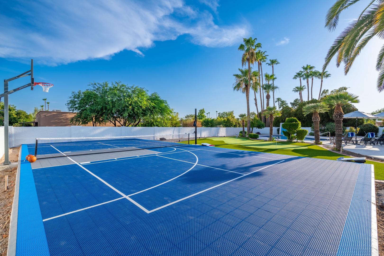 A full-size sport court awaits your friendly competition under swaying palms and sunny skies—perfect for morning pickup games or evening matches.