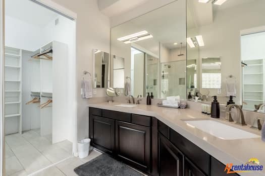 Step into your spacious master bathroom featuring dual vanities, a luxurious walk-in shower, and sleek modern finishes for the perfect morning routine.
