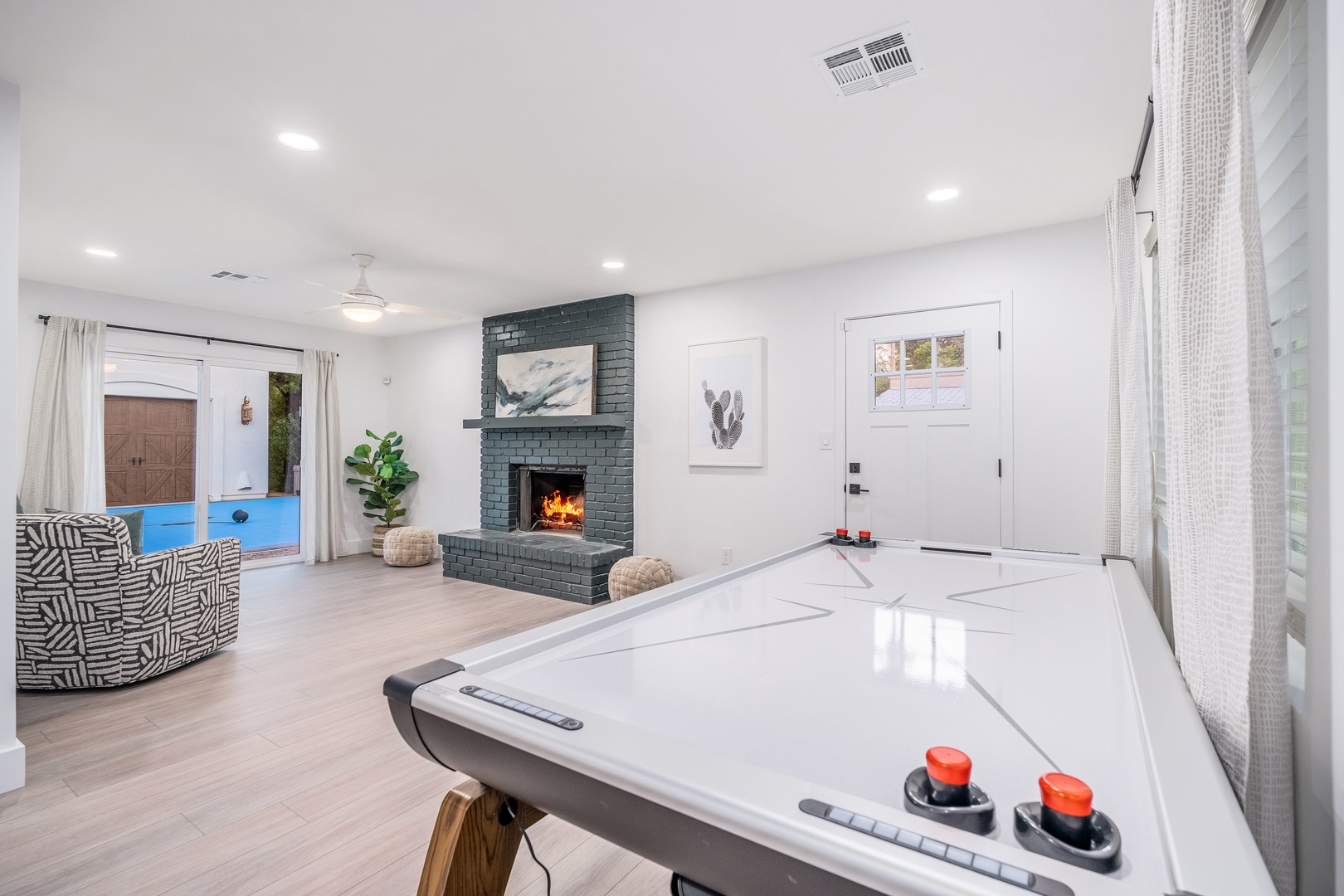 Unwind after a day of adventure in your bright, open living space with air hockey and a cozy fireplace—perfect for family game nights or relaxing with friends.