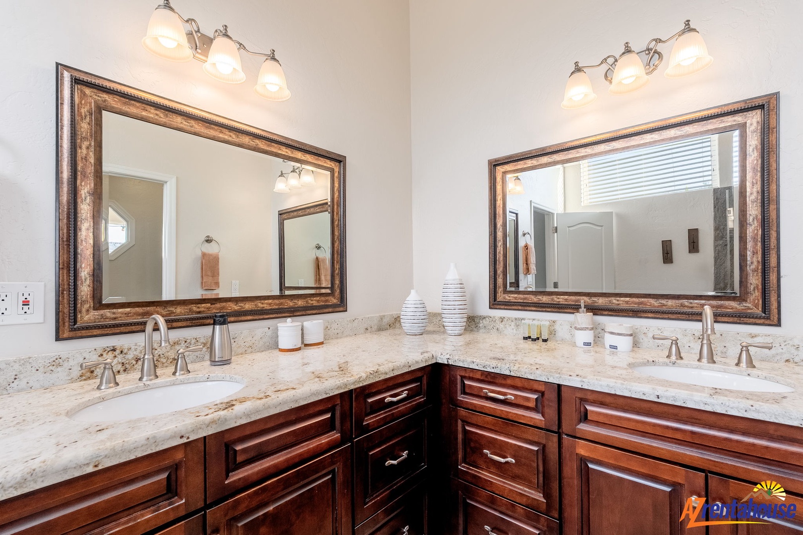 Step into your spacious dual-sink vanity with elegant granite countertops, rich wood cabinetry, and warm lighting—your personal oasis for morning routines and evening wind-downs.