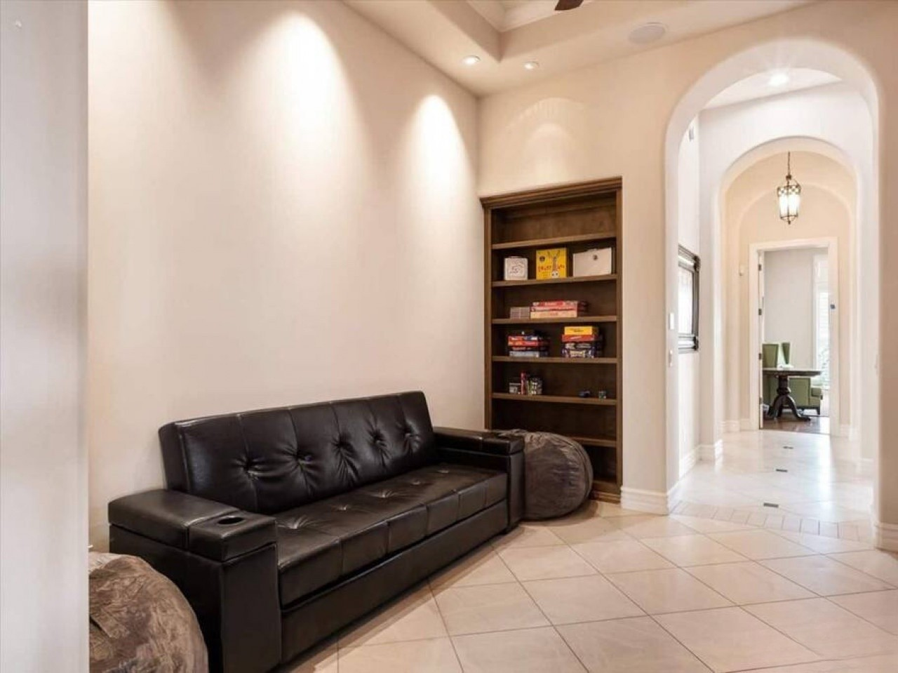 Settle into the sleek leather sofa and choose your favorite board game from the built-in shelves. Soft lighting and elegant archways create a welcoming retreat for downtime between adventures.