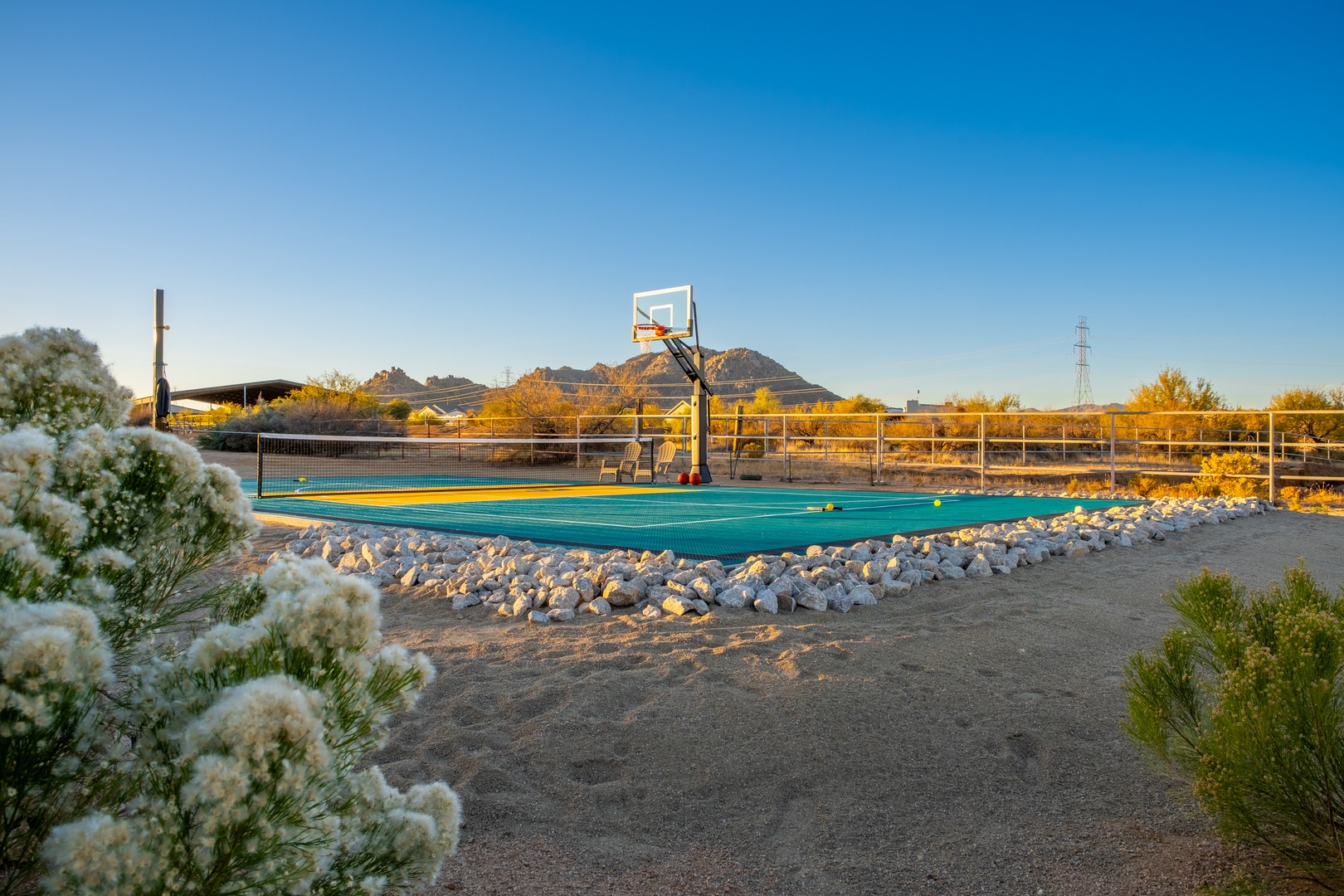 A vibrant outdoor sports court with mountain views sets the stage for friendly competition under sunny Arizona skies.