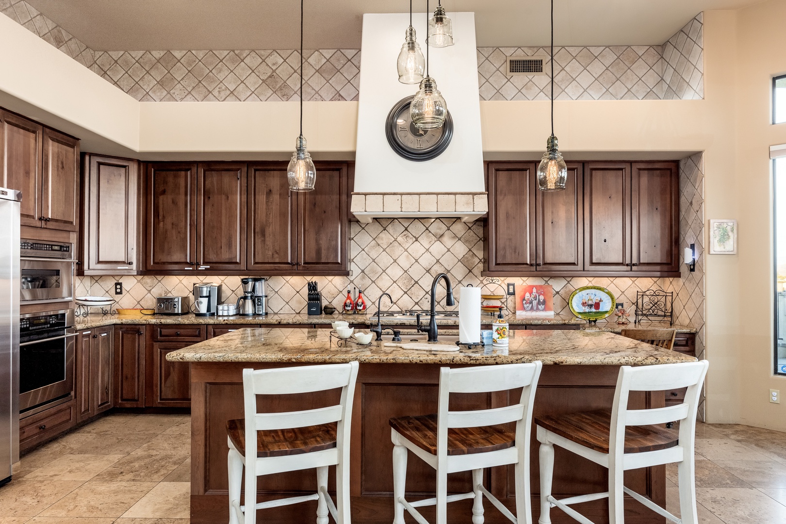 Cook your favorite meals in this spacious gourmet kitchen with rich wood cabinetry, granite counters, and a large center island where you can gather with loved ones.