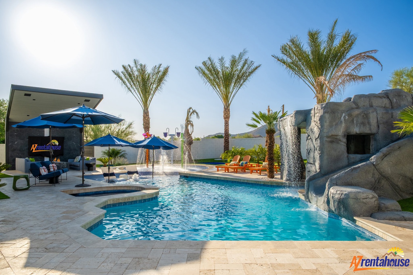 Dive into your private oasis with cascading waterfalls, tropical palms, and sunny poolside lounging beneath desert skies.