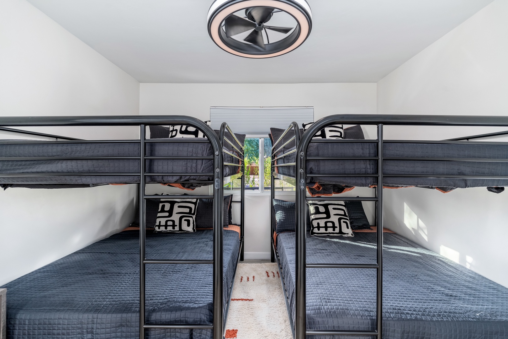 Your group can rest easy in this cozy bunk room, where four welcoming beds await after a day of adventure. Bright, airy, and thoughtfully designed with a modern ceiling fan for comfort.