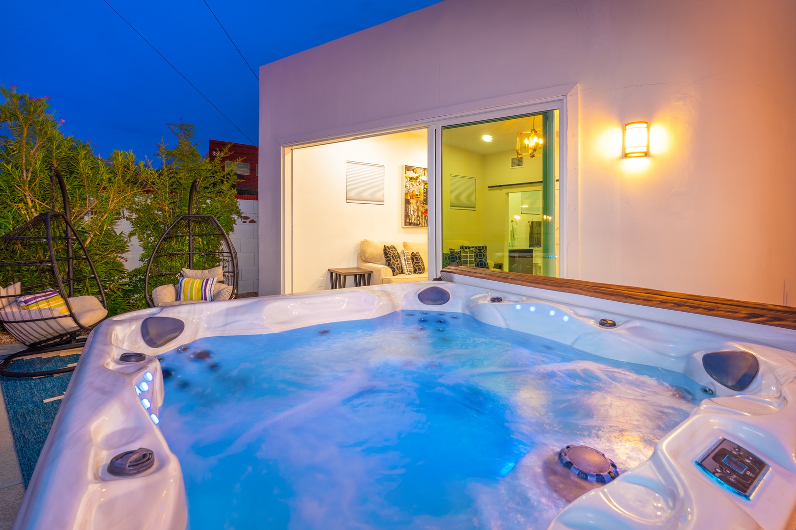 Soak under the stars in your private hot tub, perfectly lit for evening relaxation. Watch the sky deepen as you unwind with soothing jets and peaceful tropical greenery framing your terrace escape.