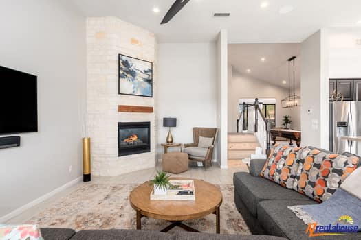 Sink into this stylish living space where modern comfort meets warm elegance, perfect for relaxing evenings by your cozy fireplace.
