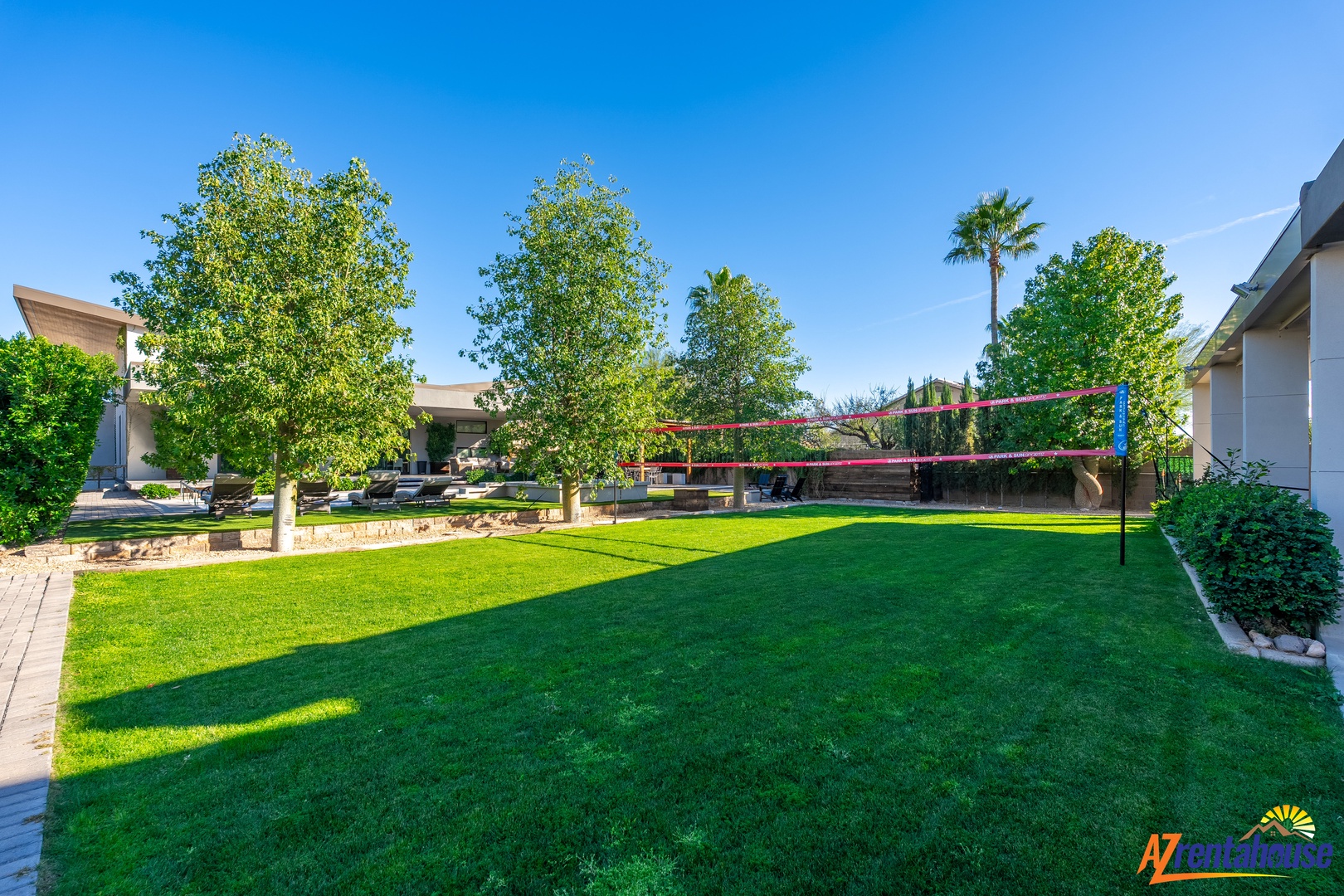 Challenge friends to a volleyball match on your private court, surrounded by lush landscaping and modern desert living.