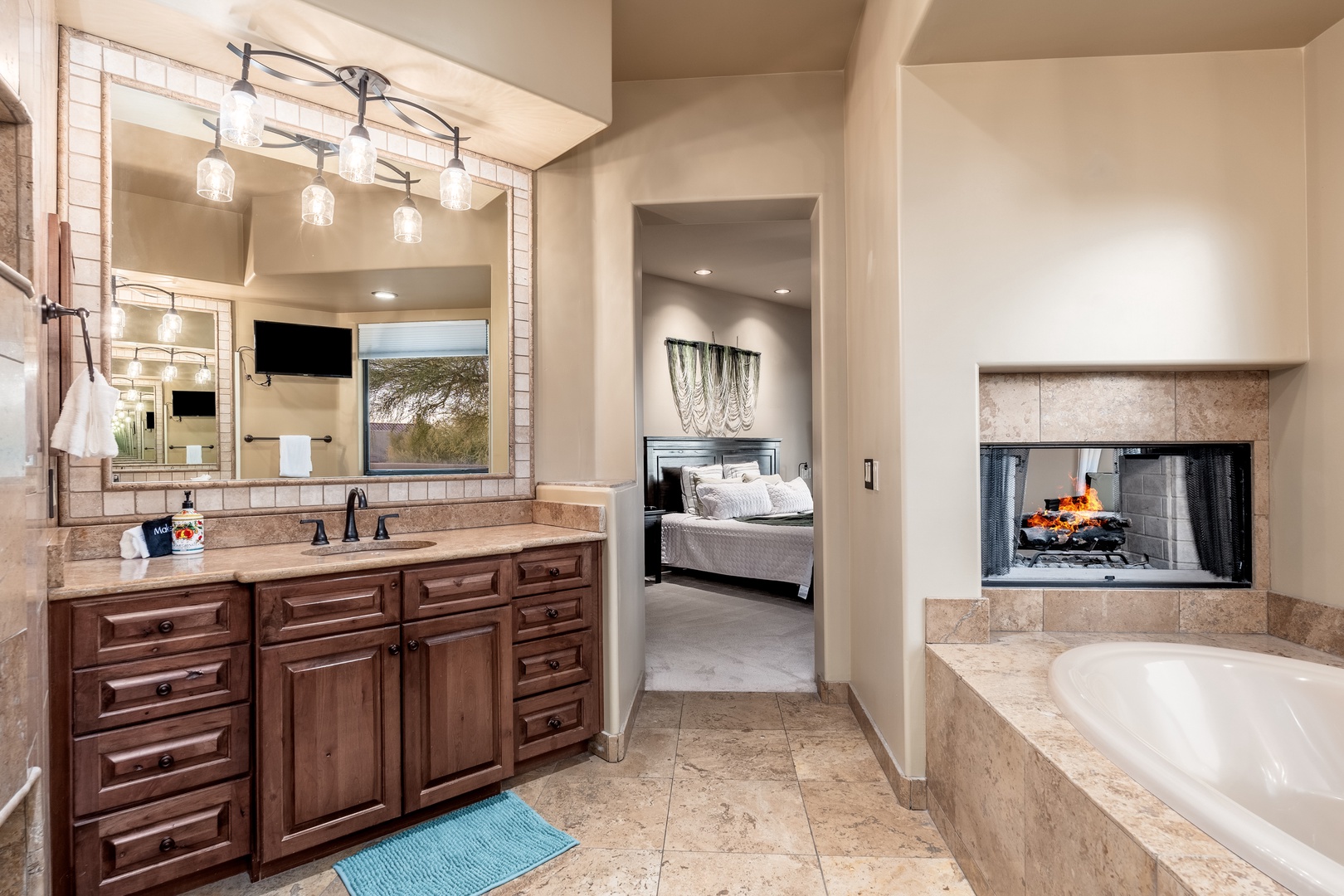 Unwind in your luxurious ensuite, complete with a soaking tub, dual vanities, and a cozy two-way fireplace connecting to your bedroom—your perfect retreat.