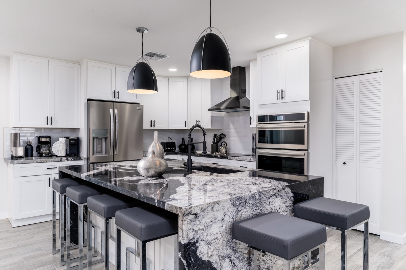Your culinary haven features stunning marble countertops, stainless steel appliances, and a center island perfect for gathering over morning coffee or preparing memorable meals together.