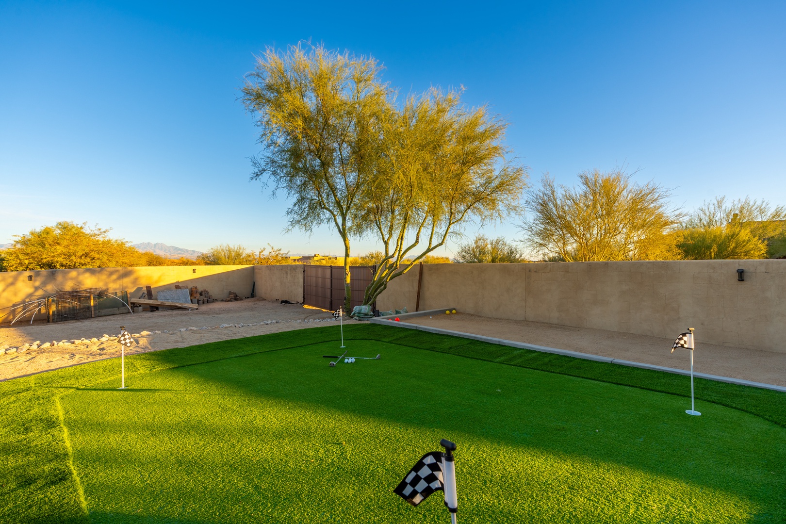 Practice your putting skills on a private backyard putting green, surrounded by desert trees and open skies—perfect for friendly competition or unwinding after exploring the area.