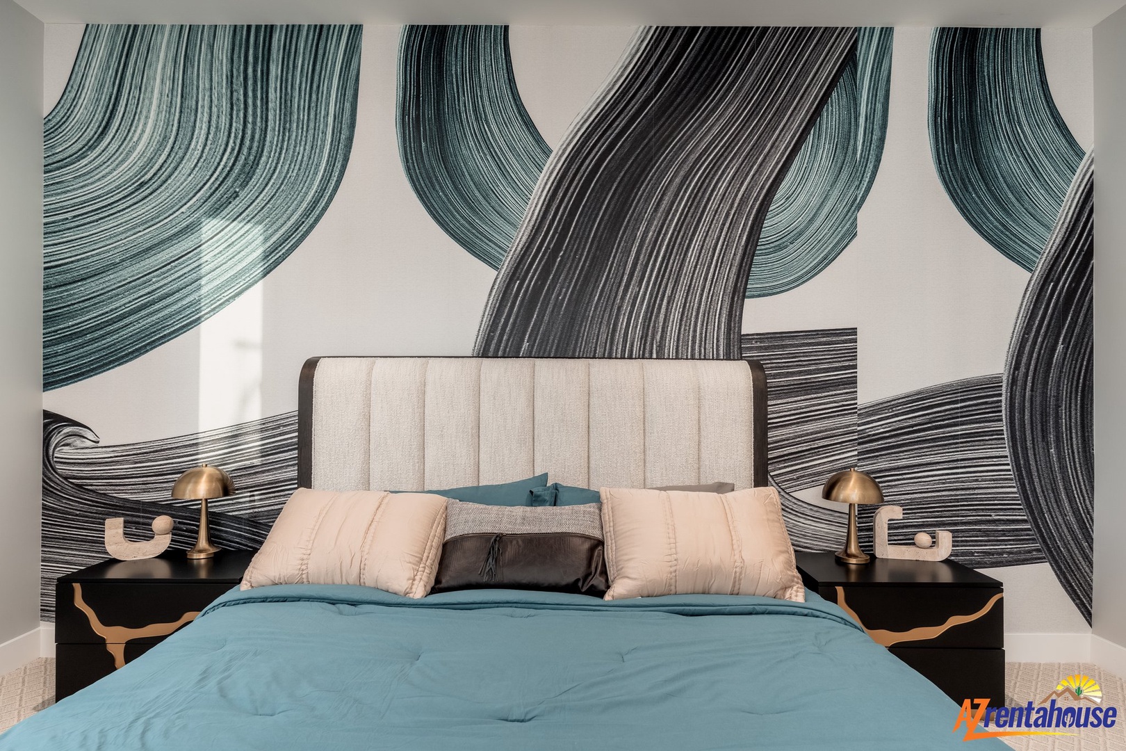 Drift off beneath stunning flowing artwork in this beautifully designed bedroom with plush bedding and elegant modern touches.
