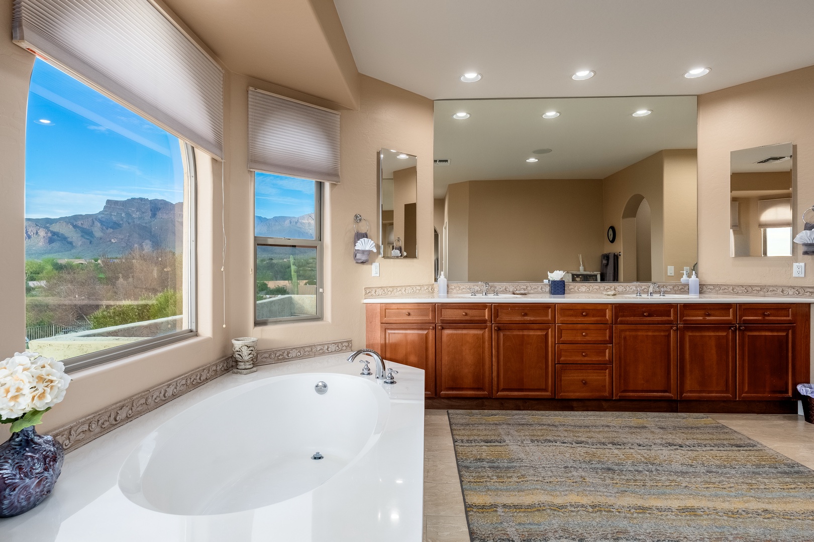 Soak in your luxurious tub while mountains frame your view through expansive windows, creating a spa-like sanctuary that blends indulgence with breathtaking natural beauty.
