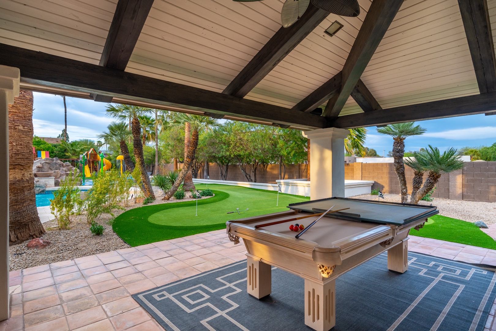 Enjoy endless fun under your private covered patio with a pool table, ping pong, and your own putting green surrounded by lush palms and sparkling pool views.