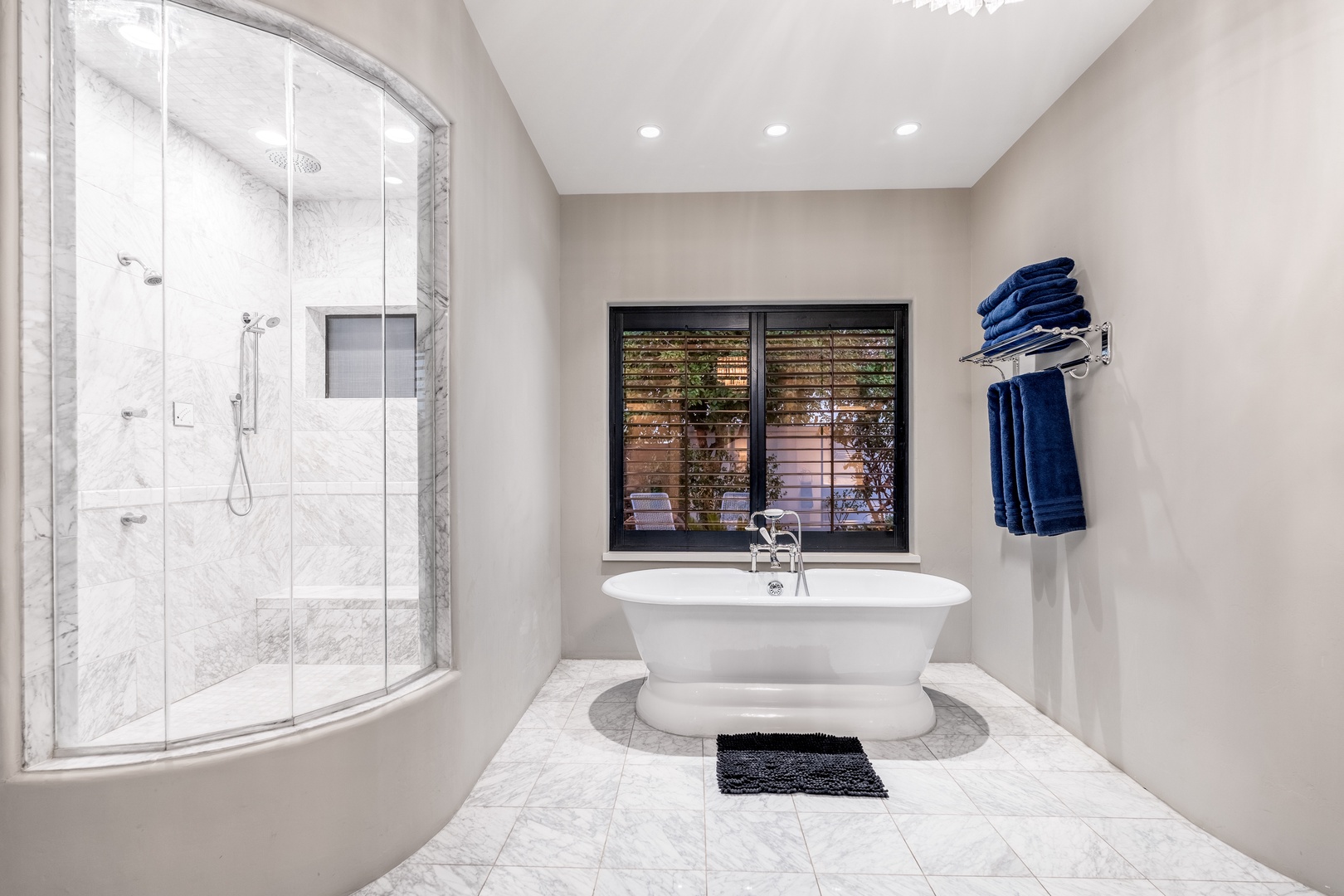 Sink into the freestanding soaking tub after a day of adventure, with fresh towels at your fingertips and a spacious walk-in shower waiting nearby.