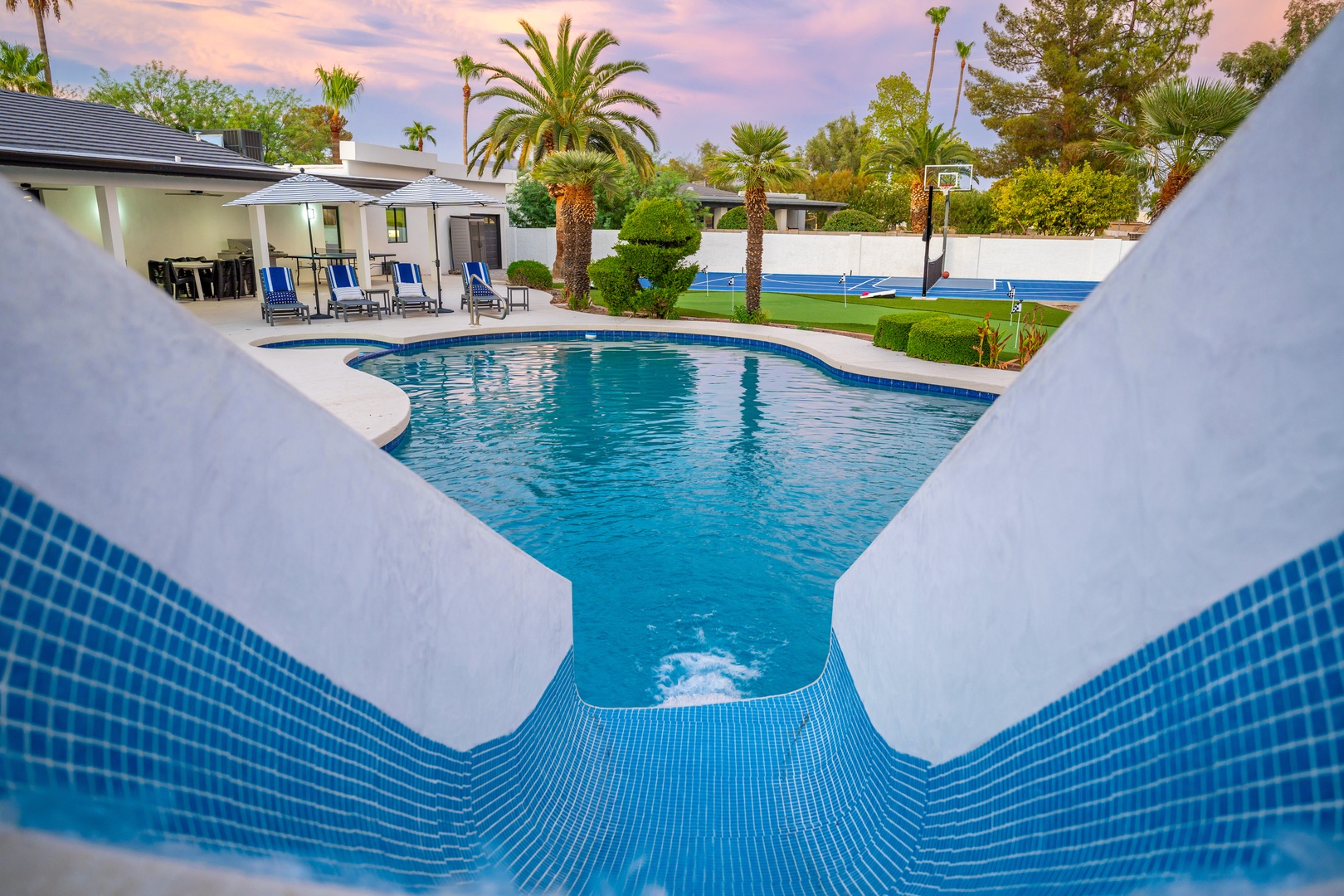 Dive into your private paradise, where crystal-clear waters meet lush palms and spacious lounging areas—your perfect retreat for sunny days and starlit evenings awaits.