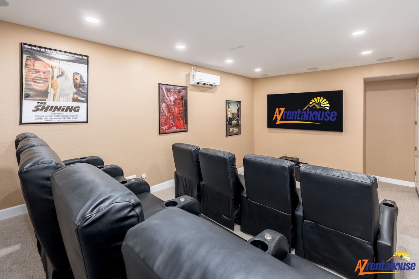 Sink into plush leather recliners and enjoy your favorite films in this private theater room, complete with movie posters and stadium seating.