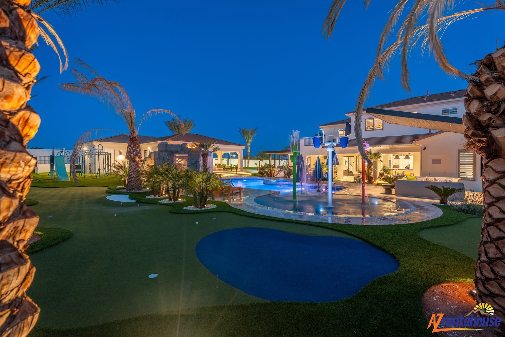 Luxurious villa complex featuring pools, water features, and manicured grounds under evening twilight skies.